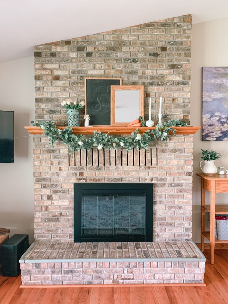 Large brick fireplace with whimsical easter decor.