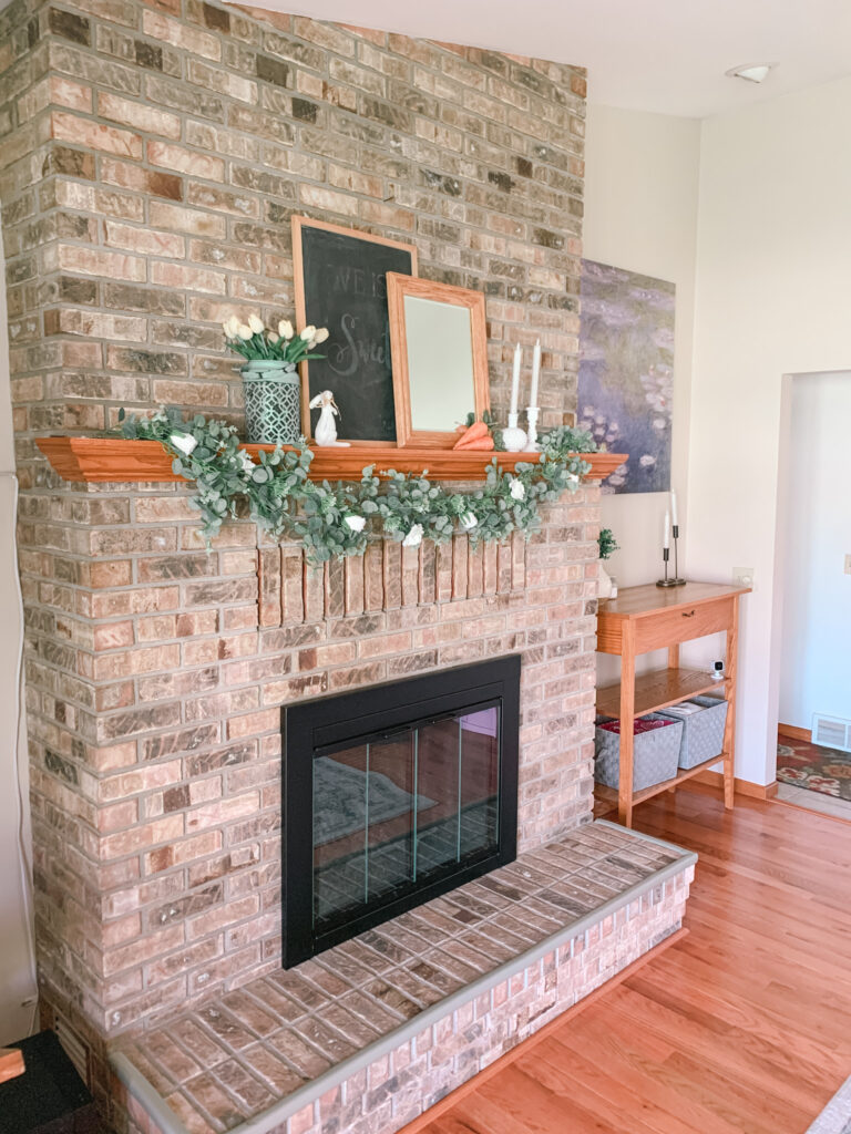 Whimsical Easter Mantle. Large brick fireplace with Easter decor.